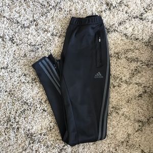 Gray Adidas three stripe sweatpants.